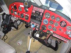 The well-appointed cockpit of 2008 in a 1960 airplane.  You can see 2 of the 5 GPSes I normally have in flight. One GPS sits on the right side glareshield and talks to the HP Windows Mobile PDA on the yoke.  Another one is in the Garmin GX-60 IFR-certified GPS/Comm in the center stack. Not visible here are my Spot Messenger, the APRS tracking device, and my ATT Tilt smartphone that is also running an emergency backup copy of AnywhereMap. Cockpit - Instrument Panel.JPG